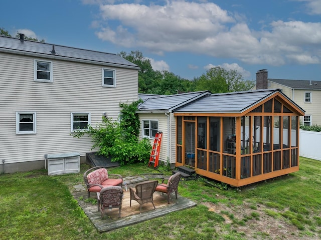 17 Plainfield St, Enfield, CT 06082 - rear view of property with a sunroom and a lawn