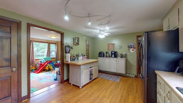 17 Plainfield St, Enfield, CT 06082 - kitchen featuring light countertops, freestanding refrigerator, light wood-type flooring, ceiling fan, and white cabinets