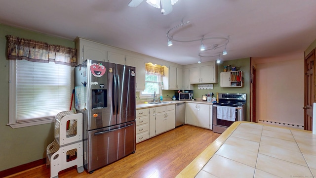 17 Plainfield St, Enfield, CT 06082 - kitchen featuring appliances with stainless steel finishes, a baseboard heating unit, light countertops, and light wood-type flooring