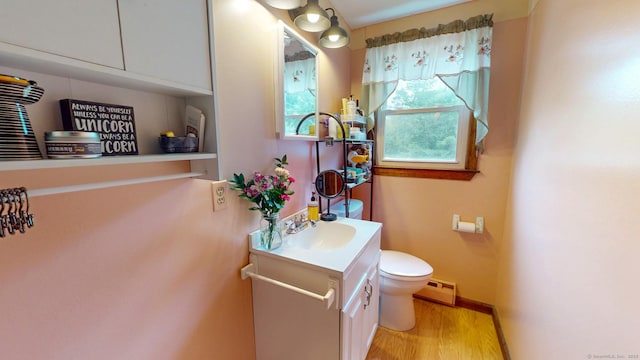 17 Plainfield St, Enfield, CT 06082 - bathroom with vanity, a baseboard heating unit, and wood finished floors