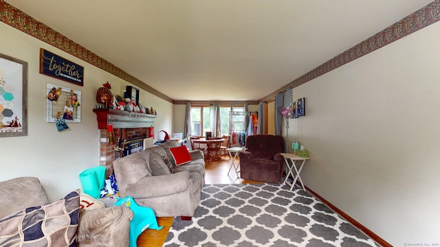 17 Plainfield St, Enfield, CT 06082 - living room with wood finished floors and a brick fireplace