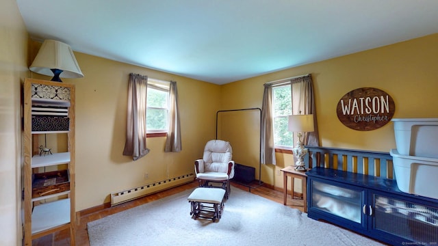 17 Plainfield St, Enfield, CT 06082 - living area featuring a baseboard heating unit and wood finished floors