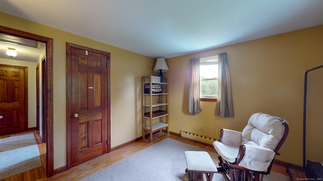 17 Plainfield St, Enfield, CT 06082 - living area with a baseboard heating unit and wood finished floors