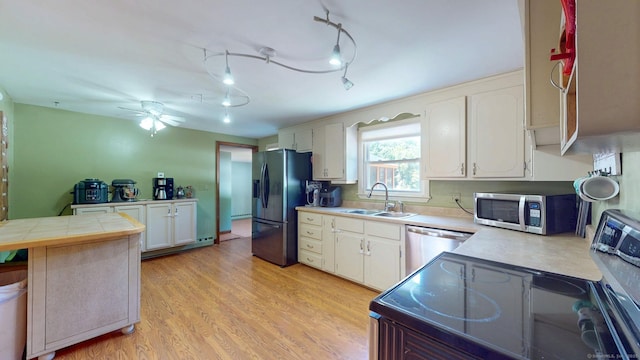 17 Plainfield St, Enfield, CT 06082 - kitchen featuring stainless steel appliances, white cabinets, light wood finished floors, a ceiling fan, and tile counters