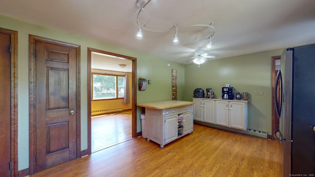 17 Plainfield St, Enfield, CT 06082 - kitchen with freestanding refrigerator, white cabinetry, light wood-style flooring, and light countertops