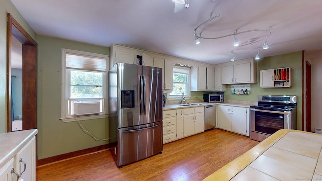 17 Plainfield St, Enfield, CT 06082 - kitchen with stainless steel appliances, light wood-style flooring, light countertops, and white cabinets
