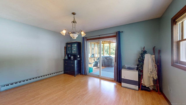 17 Plainfield St, Enfield, CT 06082 - spare room featuring a baseboard radiator, wood finished floors, a chandelier, and heating unit