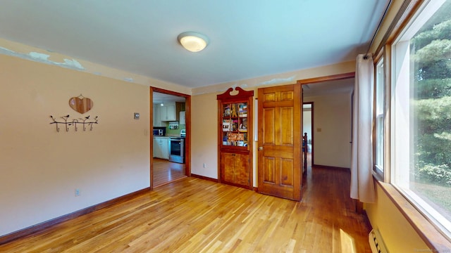 17 Plainfield St, Enfield, CT 06082 - empty room featuring light wood finished floors and a baseboard radiator