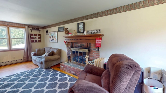 17 Plainfield St, Enfield, CT 06082 - living room featuring wood finished floors, a fireplace, and a baseboard radiator