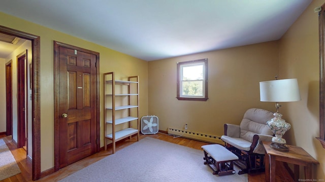 17 Plainfield St, Enfield, CT 06082 - living area with a baseboard heating unit and wood finished floors