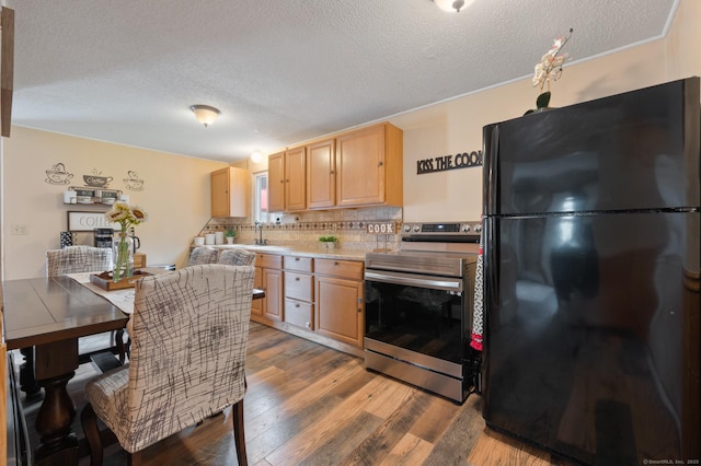 529 Orchard St, Rocky Hill, CT 06067 - kitchen featuring freestanding refrigerator, stainless steel electric stove, a textured ceiling, wood finished floors, and decorative backsplash