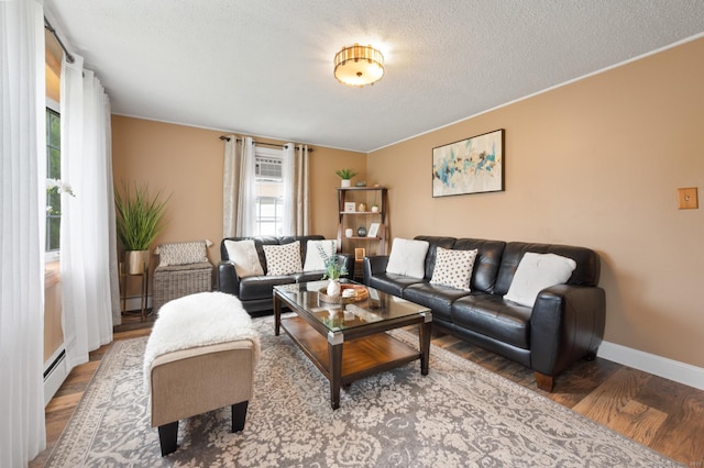 529 Orchard St, Rocky Hill, CT 06067 - living room featuring wood finished floors, a baseboard heating unit, and a textured ceiling