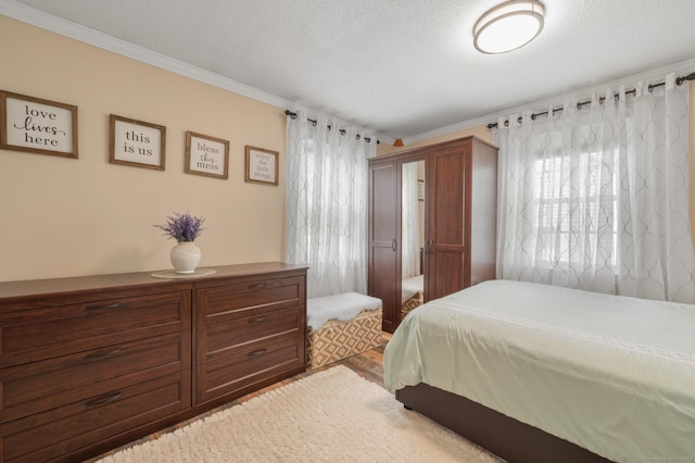 529 Orchard St, Rocky Hill, CT 06067 - bedroom featuring crown molding, multiple windows, and a textured ceiling