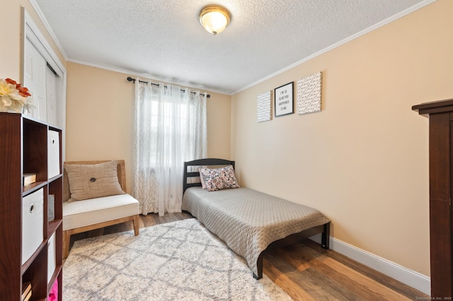 529 Orchard St, Rocky Hill, CT 06067 - bedroom featuring wood finished floors, ornamental molding, and a textured ceiling