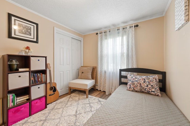 529 Orchard St, Rocky Hill, CT 06067 - bedroom with crown molding, wood finished floors, a textured ceiling, and a closet