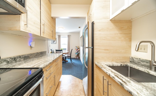 3 France St Unit B, Norwalk, CT 06851 - kitchen featuring stainless steel appliances, light stone countertops, light colored carpet, and light brown cabinets