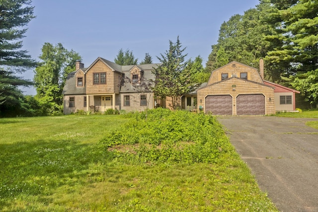 317 Turnpike Rd, Somers, CT 06071 - view of front facade featuring a chimney, asphalt driveway, an attached garage, and a front yard