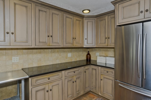 317 Turnpike Rd, Somers, CT 06071 - kitchen featuring freestanding refrigerator, tasteful backsplash, dark stone countertops, and a textured ceiling