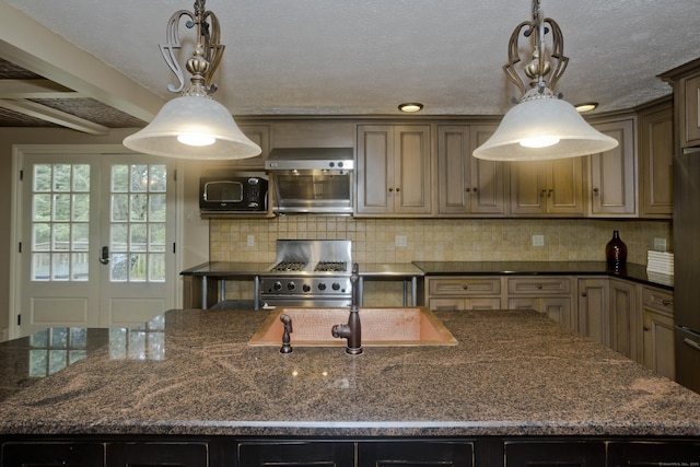 317 Turnpike Rd, Somers, CT 06071 - kitchen with gas range, a center island with sink, tasteful backsplash, hanging light fixtures, and dark stone counters