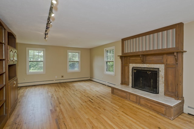 317 Turnpike Rd, Somers, CT 06071 - unfurnished living room with light wood-style flooring, track lighting, a high end fireplace, and baseboard heating