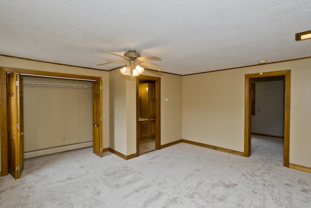 317 Turnpike Rd, Somers, CT 06071 - unfurnished bedroom with baseboard heating, carpet flooring, a textured ceiling, a closet, and a ceiling fan