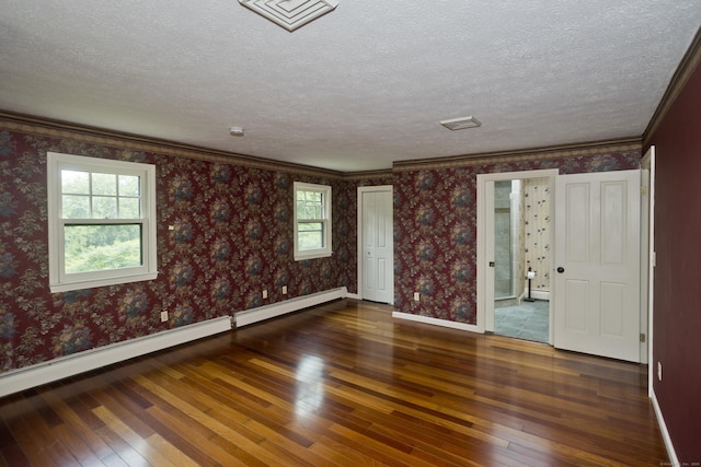 317 Turnpike Rd, Somers, CT 06071 - spare room with wood-type flooring, a baseboard heating unit, a textured ceiling, and crown molding