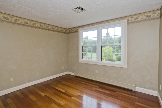 317 Turnpike Rd, Somers, CT 06071 - unfurnished room with a baseboard radiator, hardwood / wood-style flooring, plenty of natural light, and a textured ceiling