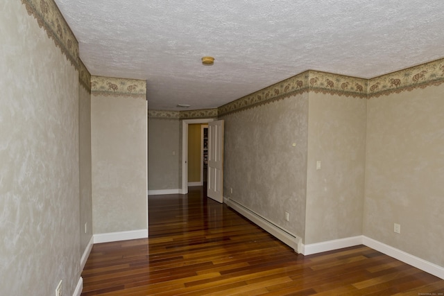 317 Turnpike Rd, Somers, CT 06071 - unfurnished room with a baseboard radiator, wood finished floors, a textured ceiling, and a smoke detector