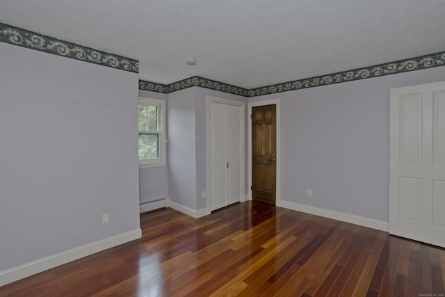 317 Turnpike Rd, Somers, CT 06071 - unfurnished bedroom with a baseboard heating unit and wood finished floors