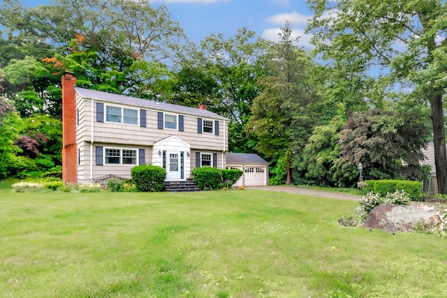343 Steiner St, Fairfield, CT 06825 - colonial inspired home featuring a chimney, a front yard, and a garage