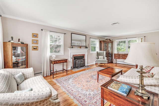 343 Steiner St, Fairfield, CT 06825 - living area with ornamental molding, healthy amount of natural light, light wood finished floors, and a brick fireplace