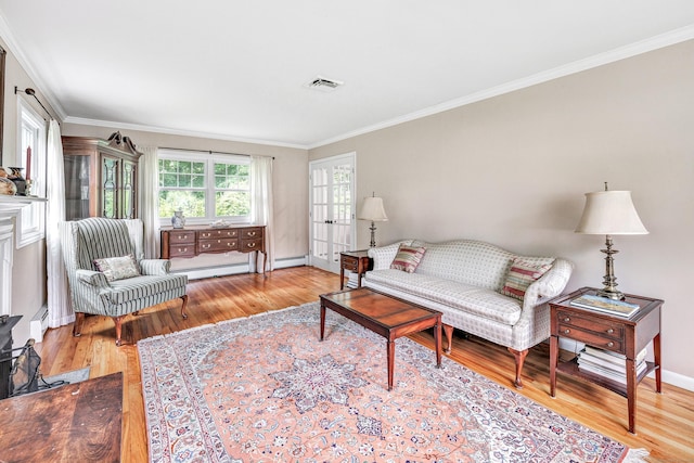 343 Steiner St, Fairfield, CT 06825 - living room featuring wood finished floors, crown molding, and a baseboard heating unit