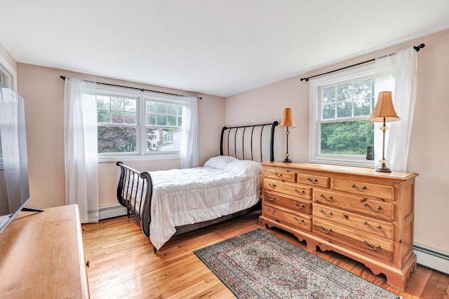 343 Steiner St, Fairfield, CT 06825 - bedroom with light wood finished floors and a baseboard heating unit