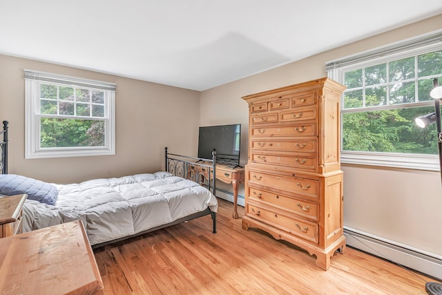 343 Steiner St, Fairfield, CT 06825 - bedroom with baseboard heating, multiple windows, and light wood-style flooring