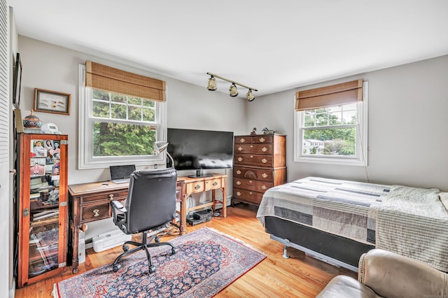 343 Steiner St, Fairfield, CT 06825 - bedroom featuring rail lighting, wood finished floors, and a desk