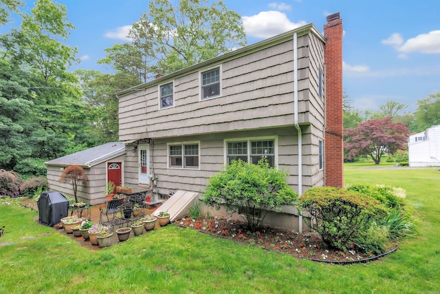 343 Steiner St, Fairfield, CT 06825 - back of house with a chimney and a lawn