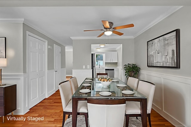 189 High Top Cir W Unit 189, Hamden, CT 06514 - dining room with a decorative wall, wood finished floors, crown molding, a ceiling fan, and a wainscoted wall