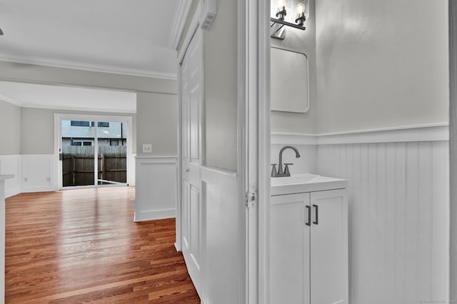 189 High Top Cir W Unit 189, Hamden, CT 06514 - bathroom with crown molding, a decorative wall, wainscoting, vanity, and wood finished floors