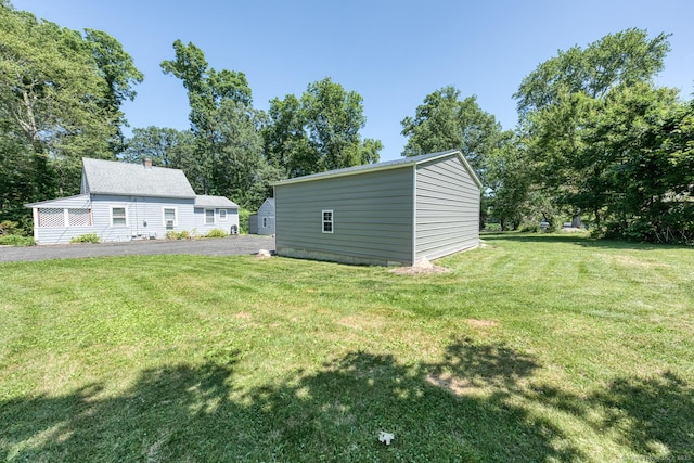 63 Fox Trl, Coventry, CT 06238 - view of green lawn with view of scattered trees and an outbuilding