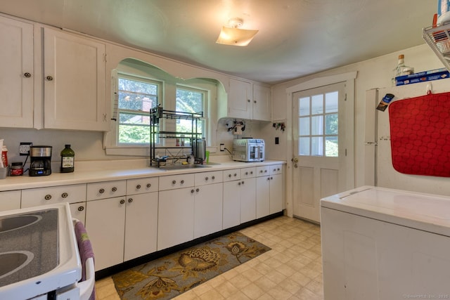 63 Fox Trl, Coventry, CT 06238 - kitchen featuring plenty of natural light, washer / dryer, light floors, and white cabinets