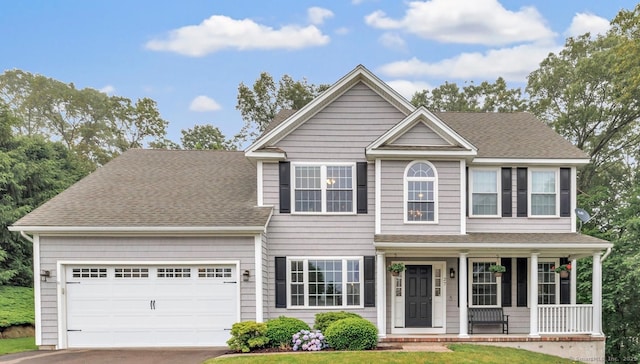 27 Bartlett Ln Unit 27, Shelton, CT 06484 - view of front of home featuring a porch, asphalt driveway, roof with shingles, and a garage