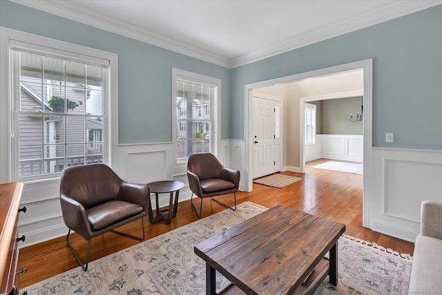 27 Bartlett Ln Unit 27, Shelton, CT 06484 - living room with healthy amount of natural light, wainscoting, crown molding, light wood-style floors, and a decorative wall