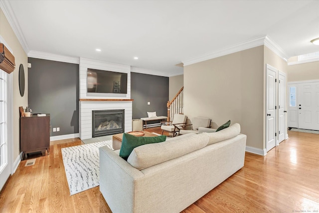 27 Bartlett Ln Unit 27, Shelton, CT 06484 - living room featuring ornamental molding, light wood-type flooring, a fireplace, stairs, and recessed lighting