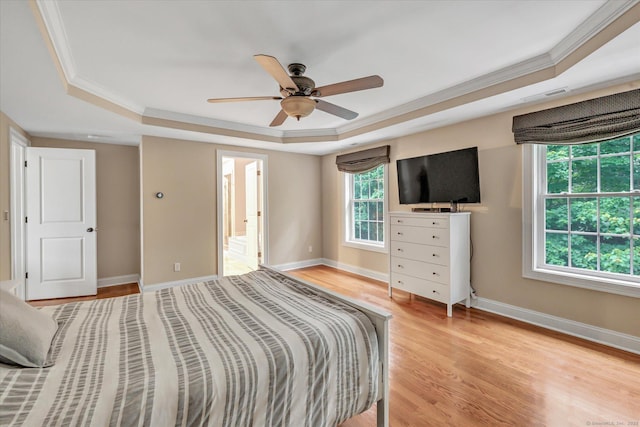 27 Bartlett Ln Unit 27, Shelton, CT 06484 - bedroom featuring a tray ceiling, light wood-style floors, ornamental molding, a ceiling fan, and ensuite bath