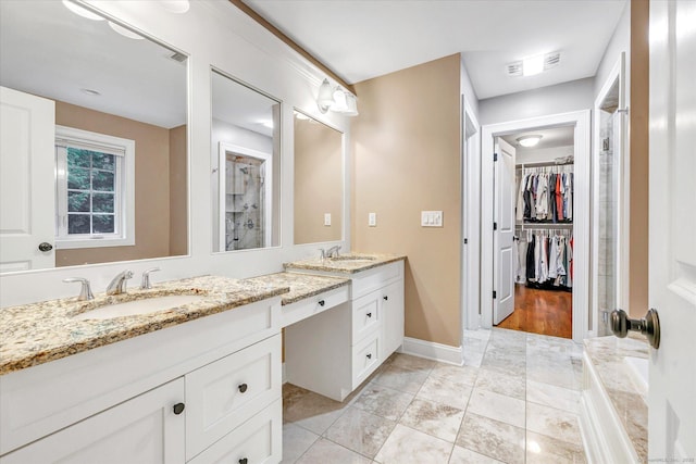 27 Bartlett Ln Unit 27, Shelton, CT 06484 - bathroom with double vanity, a spacious closet, tile patterned floors, and a shower
