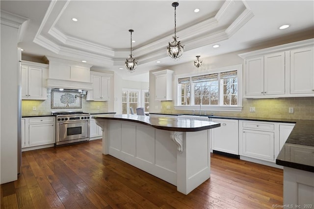 275 Chestnut Grv, Guilford, CT 06437 - kitchen with stainless steel stove, a tray ceiling, dark countertops, white dishwasher, and crown molding