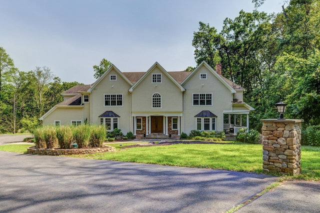 275 Chestnut Grv, Guilford, CT 06437 - view of front of home featuring a chimney, a front yard, and a standing seam roof