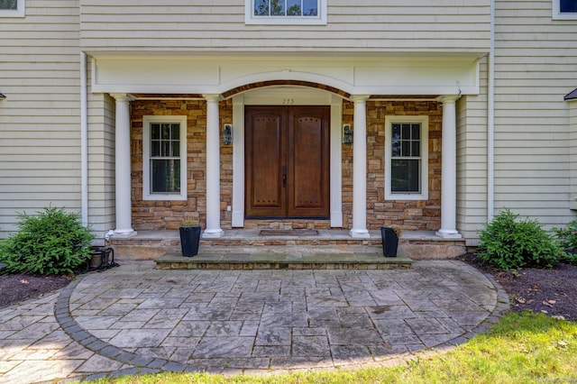 275 Chestnut Grv, Guilford, CT 06437 - view of exterior entry featuring stone siding and covered porch