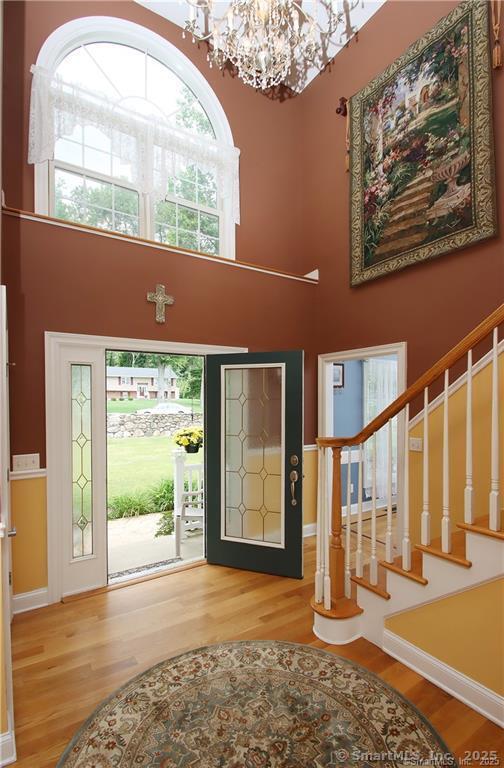 109 Davis Rd, Seymour, CT 06483 - entryway with a chandelier, wood finished floors, a high ceiling, and stairway