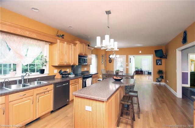 109 Davis Rd, Seymour, CT 06483 - kitchen with dishwashing machine, stainless steel microwave, electric stove, a chandelier, and light wood finished floors